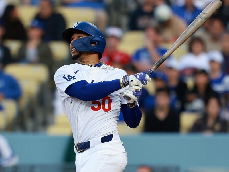 May 17, 2024; Los Angeles, California, USA;  Los Angeles Dodgers shortstop Mookie Betts (50) hits a home run during the first inning against the Cincinnati Reds at Dodger Stadium. Mandatory Credit: Kiyoshi Mio-USA TODAY Sports