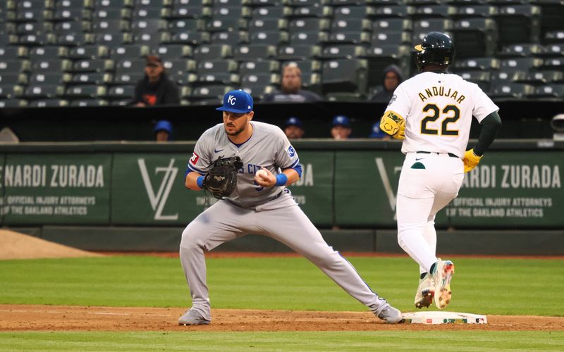 Jun 19, 2024; Oakland, California, USA; Kansas City Royals first baseman Vinnie Pasquantino (9) catches the ball against Oakland Athletics left fielder Miguel Andujar (22) during the fifth inning at Oakland-Alameda County Coliseum. Mandatory Credit: Kelley L Cox-USA TODAY Sports