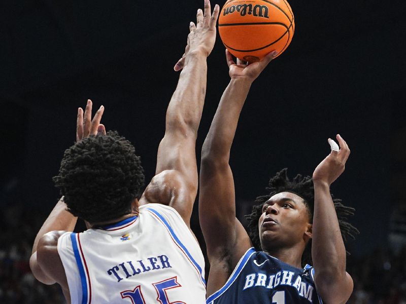 Jan 31, 2026; Lawrence, Kansas, USA; BYU Cougars guard Robert Wright III (1) shoots against Kansas Jayhawks forward Bryson Tiller (15) during the first half at Allen Fieldhouse. Mandatory Credit: Jay Biggerstaff-Imagn Images