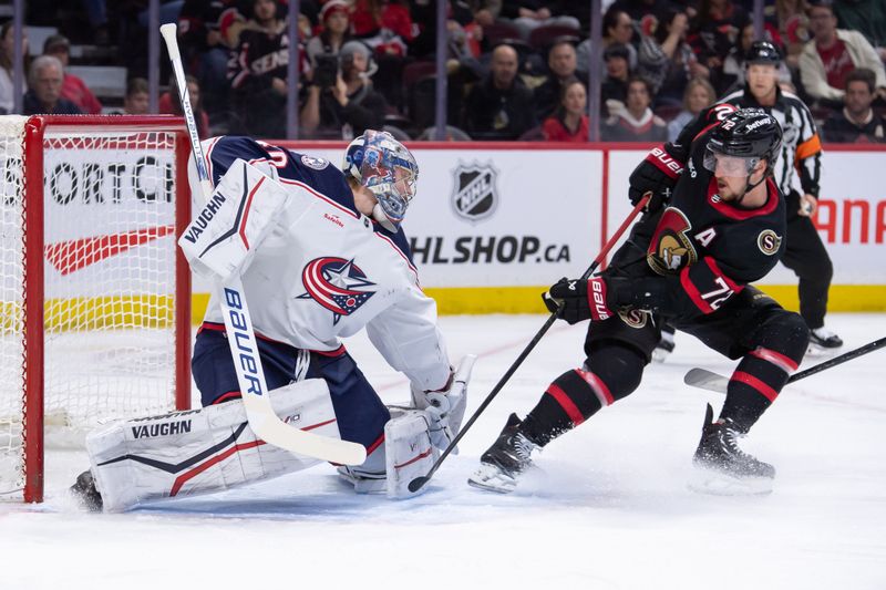 Feb 13, 2024; Ottawa, Ontario, CAN; Columbus Blue Jackets goalie Daniil Tarasov (40) makes a save in front of Ottawa Senators defenseman Thomas Chabot (72) in the first period at the Canadian Tire Centre. Mandatory Credit: Marc DesRosiers-USA TODAY Sports