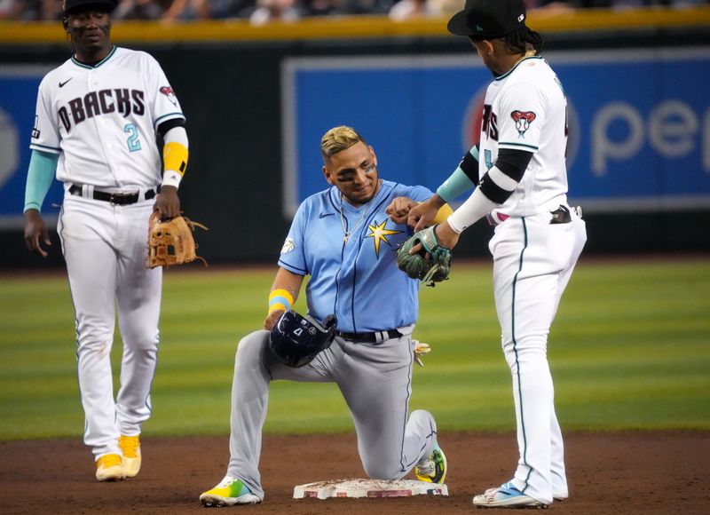 Jun 29, 2023; Phoenix, Arizona, USA; Arizona Diamondbacks second baseman Ketel Marte (4) fist bumps Tampa Bay Rays third baseman Isaac Paredes (17) after his double at Chase Field. Mandatory Credit: Joe Rondone-USA TODAY Sports