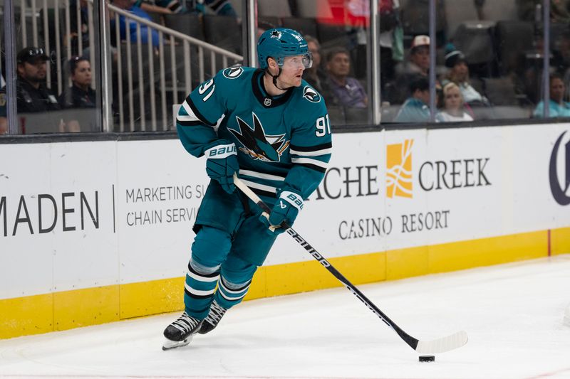 Oct 1, 2024; San Jose, California, USA;  San Jose Sharks right wing Carl Grundstrom (91) controls the puck during the third period against the Utah Hockey Club at SAP Center at San Jose. Mandatory Credit: Stan Szeto-Imagn Images
