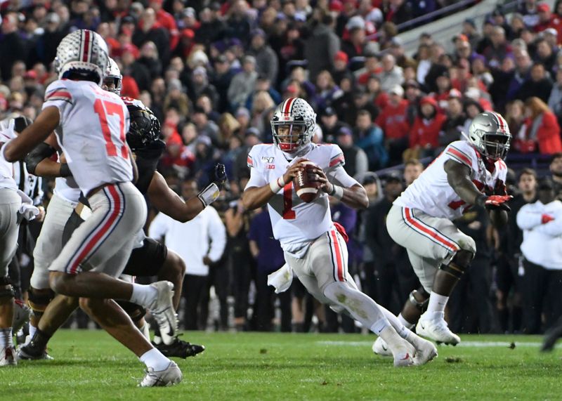 Oct 18, 2019; Evanston, IL, USA; Ohio State Buckeyes quarterback Justin Fields (1) scrambles with the ball against the Northwestern Wildcats during the first half at Ryan Field. Mandatory Credit: David Banks-USA TODAY Sports