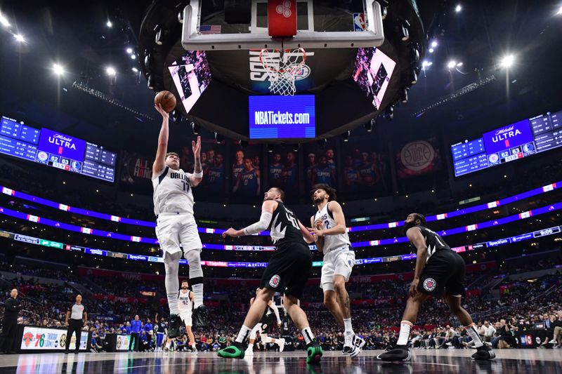 LOS ANGELES, CA - APRIL 23: Luka Doncic #77 of the Dallas Mavericks goes to the basket during the game against the LA Clippers during Round 1 Game 2 of the 2024 NBA Playoffs on April 23, 2024 at Crypto.Com Arena in Los Angeles, California. NOTE TO USER: User expressly acknowledges and agrees that, by downloading and/or using this Photograph, user is consenting to the terms and conditions of the Getty Images License Agreement. Mandatory Copyright Notice: Copyright 2024 NBAE (Photo by Adam Pantozzi/NBAE via Getty Images)