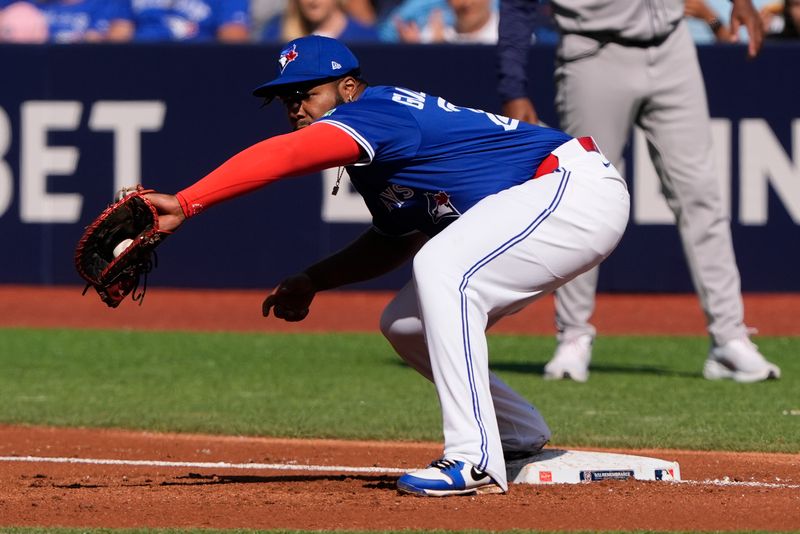 Sep 11, 2025; Toronto, Ontario, CAN; Toronto Blue Jays first baseman Vladimir Guerrero Jr. (27) gets Houston Astros center fielder Mauricio Dubon (not pictured) out at first base during the third inning at Rogers Centre. Mandatory Credit: John E. Sokolowski-Imagn Images