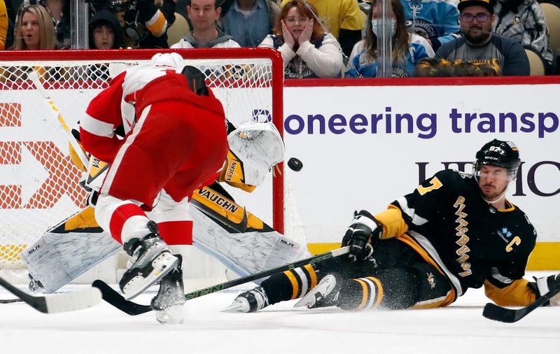 Apr 11, 2024; Pittsburgh, Pennsylvania, USA; Pittsburgh Penguins center Sidney Crosby (87) attempts to block a shot by Detroit Red Wings right wing Daniel Sprong (17) as Pittsburgh Penguins goaltender Alex Nedeljkovic (39) makes a save during the third period at PPG Paints Arena. Pittsburgh won 6-5 in overtime. Mandatory Credit: Charles LeClaire-USA TODAY Sports