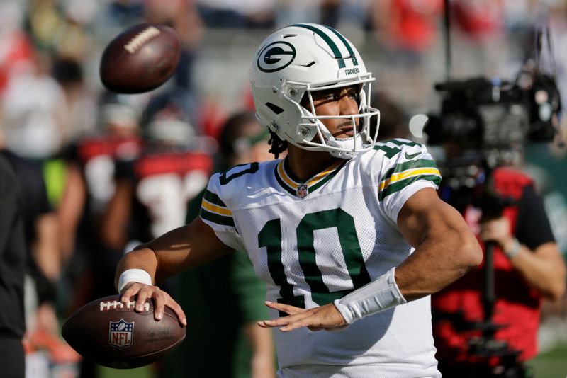 Green Bay Packers quarterback Jordan Love (10) throws during warm-ups before an NFL football game against the Houston Texans, Sunday, Oct. 20, 2024, in Green Bay, Wis. (AP Photo/Mike Roemer)