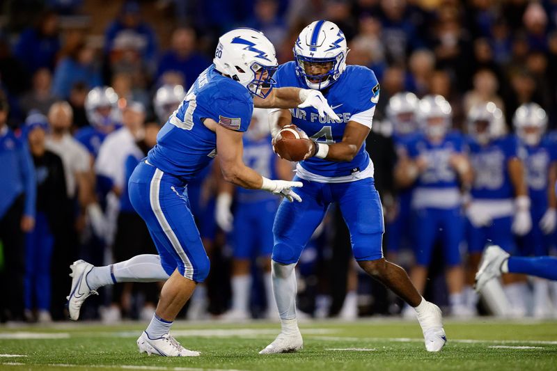 Oct 22, 2022; Colorado Springs, Colorado, USA; Air Force Falcons quarterback Haaziq Daniels (4) hands the ball off to running back Brad Roberts (20) in the fourth quarter against the Boise State Broncos at Falcon Stadium. Mandatory Credit: Isaiah J. Downing-USA TODAY Sports