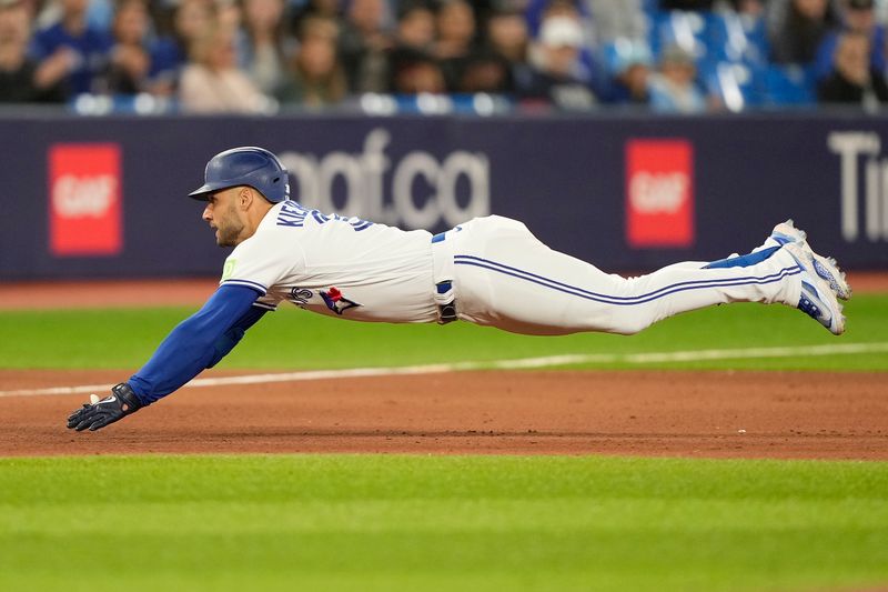 Sep 8, 2023; Toronto, Ontario, CAN; Toronto Blue Jays center fielder Kevin Kiermaier (39) dives to third base on a triple against the Kansas City Royals during the sixth inning at Rogers Centre. Mandatory Credit: John E. Sokolowski-USA TODAY Sports