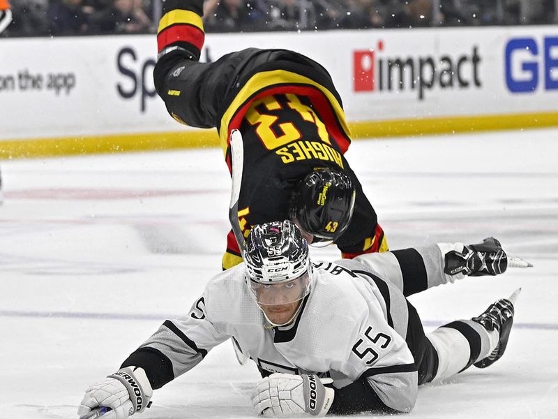 Apr 10, 2023; Los Angeles, California, USA;  Los Angeles Kings center Quinton Byfield (55) reaches for the puck in front of Vancouver Canucks defenseman Quinn Hughes (43) in the third period at Crypto.com Arena. Mandatory Credit: Jayne Kamin-Oncea-USA TODAY Sports