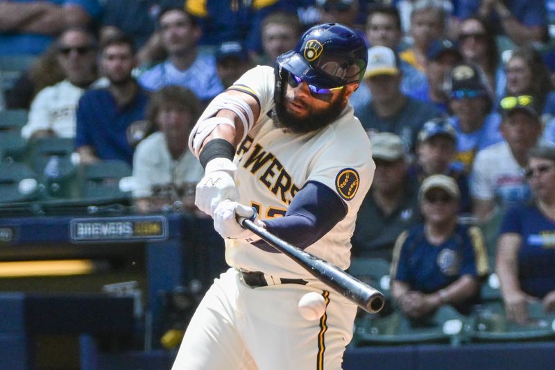 Jun 8, 2023; Milwaukee, Wisconsin, USA; Milwaukee Brewers first baseman Jon Singleton (12) drives in a run with a base hit against the Baltimore Orioles in the first inning at American Family Field. Mandatory Credit: Benny Sieu-USA TODAY Sports