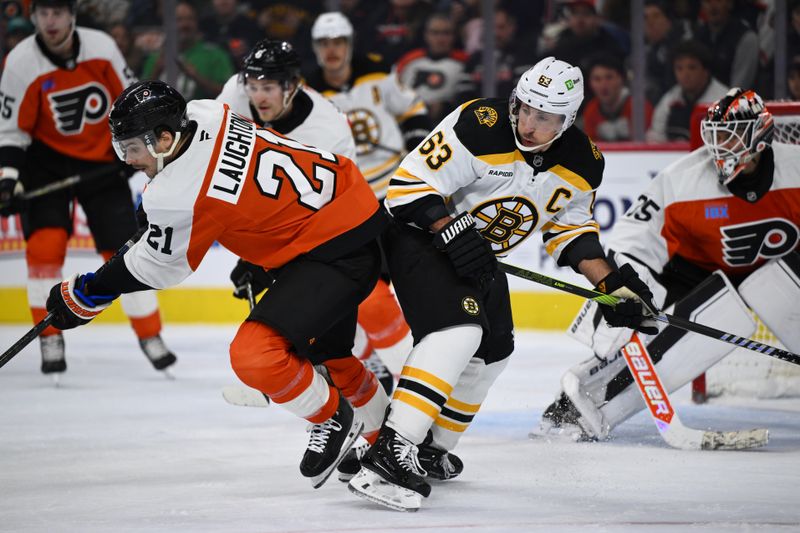 Nov 2, 2024; Philadelphia, Pennsylvania, USA; Philadelphia Flyers center Scott Laughton (21) and Boston Bruins left wing Brad Marchand (63) collide in the first period at Wells Fargo Center. Mandatory Credit: Kyle Ross-Imagn Images