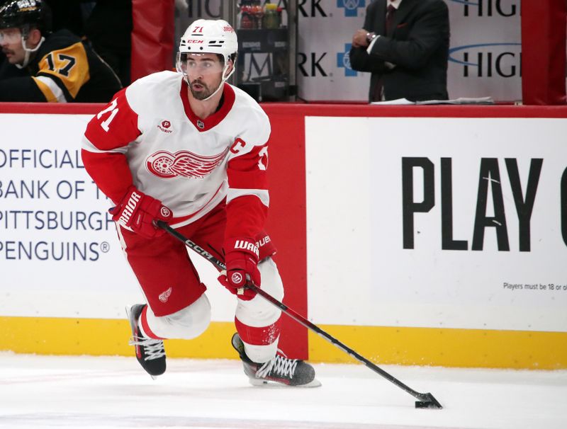 Nov 13, 2024; Pittsburgh, Pennsylvania, USA;  Detroit Red Wings center Dylan Larkin (71) skates with the puck against the Pittsburgh Penguins during the third period at PPG Paints Arena. Mandatory Credit: Charles LeClaire-Imagn Images
