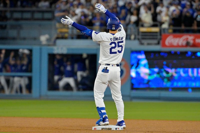 Oct 26, 2024; Los Angeles, California, USA; Los Angeles Dodgers shortstop Tommy Edman (25) celebrates at second base after hitting a double in the third inning against the New York Yankees during game two of the 2024 MLB World Series at Dodger Stadium. Mandatory Credit: Jayne Kamin-Oncea-Imagn Images