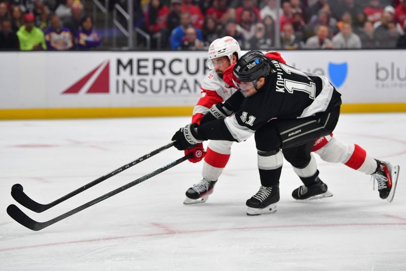 Oct 30, 2025; Los Angeles, California, USA; Detroit Red Wings center Dylan Larkin (71) plays for the puck against Los Angeles Kings center Anze Kopitar (11) during the second period at Crypto.com Arena. Mandatory Credit: Gary A. Vasquez-Imagn Images