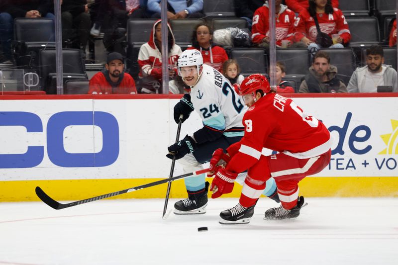 Nov 18, 2025; Detroit, Michigan, USA; Detroit Red Wings defenseman Ben Chiarot (8) skates with the puck defended by Seattle Kraken defenseman Jamie Oleksiak (24) in the third period at Little Caesars Arena. Mandatory Credit: Rick Osentoski-Imagn Images