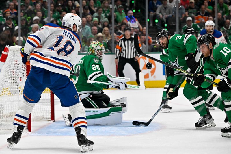 May 25, 2024; Dallas, Texas, USA; Edmonton Oilers left wing Zach Hyman (18) and Dallas Stars goaltender Jake Oettinger (29) and defenseman Chris Tanev (3) and center Ty Dellandrea (10) look for the puck in midair during the first period in game two of the Western Conference Final of the 2024 Stanley Cup Playoffs at American Airlines Center. Mandatory Credit: Jerome Miron-USA TODAY Sports