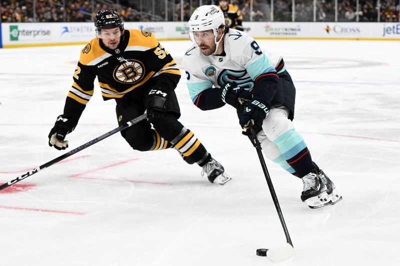 Nov 3, 2024; Boston, Massachusetts, USA; Seattle Kraken center Chandler Stephenson (9) skates with the puck against Boston Bruins defenseman Andrew Peeke (52) during the second period at the TD Garden. Mandatory Credit: Brian Fluharty-Imagn Images