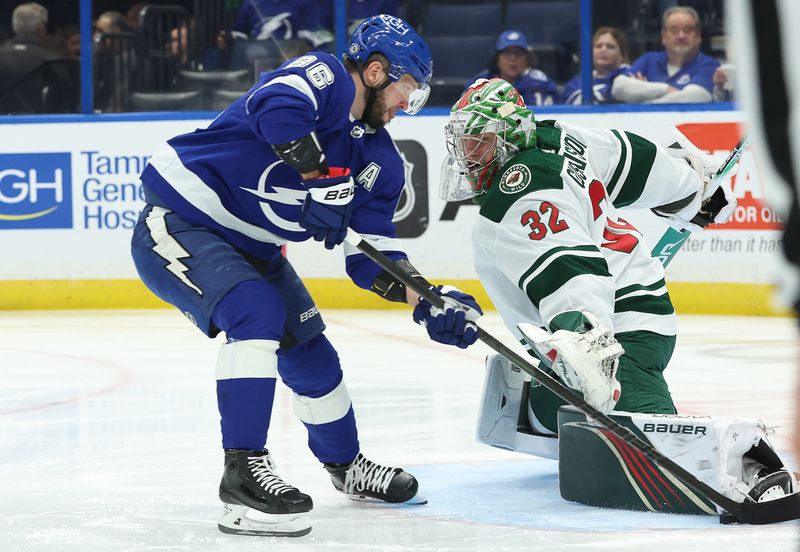 Jan 18, 2024; Tampa, Florida, USA; Tampa Bay Lightning right wing Nikita Kucherov (86) shoots as Minnesota Wild goaltender Filip Gustavsson (32) makes a save during the first period at Amalie Arena. Mandatory Credit: Kim Klement Neitzel-USA TODAY Sports