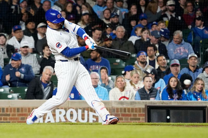 May 5, 2025; Chicago, Illinois, USA; Chicago Cubs designated hitter Seiya Suzuki (27) hits a two-run single against the San Francisco Giants during the sixth inning at Wrigley Field. Mandatory Credit: David Banks-Imagn Images