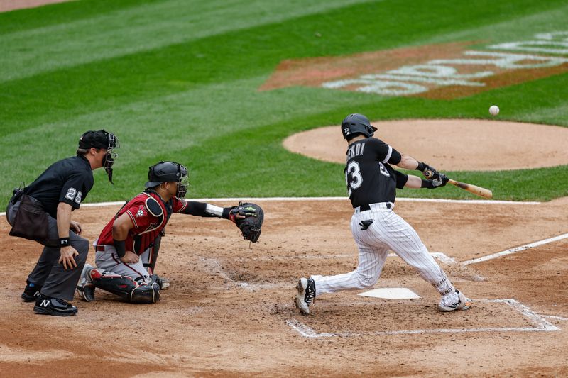 Sep 28, 2023; Chicago, Illinois, USA; Chicago White Sox left fielder Andrew Benintendi (23) singles against the Arizona Diamondbacks during the third inning at Guaranteed Rate Field. Mandatory Credit: Kamil Krzaczynski-USA TODAY Sports