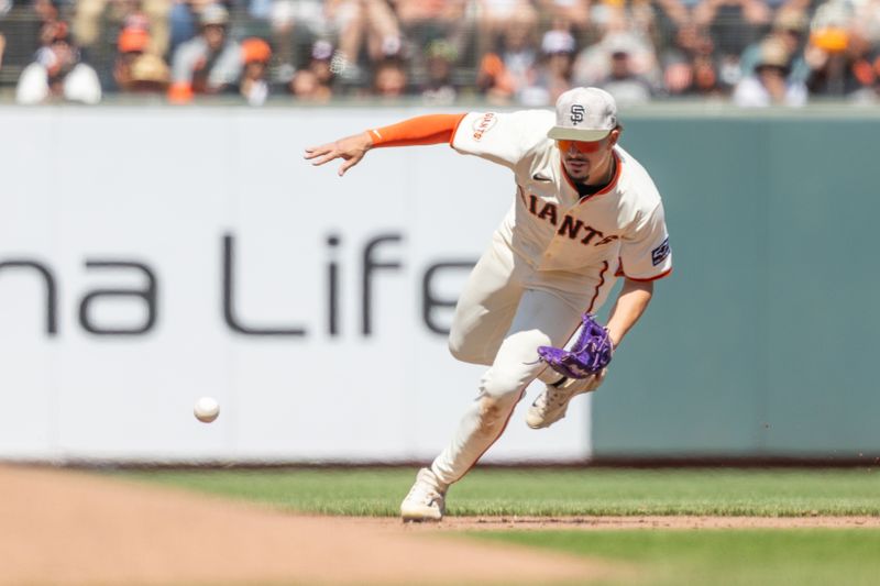 May 18, 2025; San Francisco, California, USA; San Francisco Giants shortstop Willy Adames (2) fields a grounder during the eighth inning against the Oakland Athletics at Oracle Park. Mandatory Credit: Bob Kupbens-Imagn Images