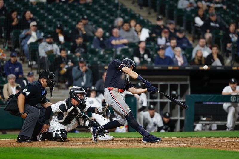 Apr 30, 2024; Chicago, Illinois, USA; Minnesota Twins outfielder Max Kepler (26) hits an RBI-sacrifice fly against the Chicago White Sox during the ninth inning at Guaranteed Rate Field. Mandatory Credit: Kamil Krzaczynski-USA TODAY Sports