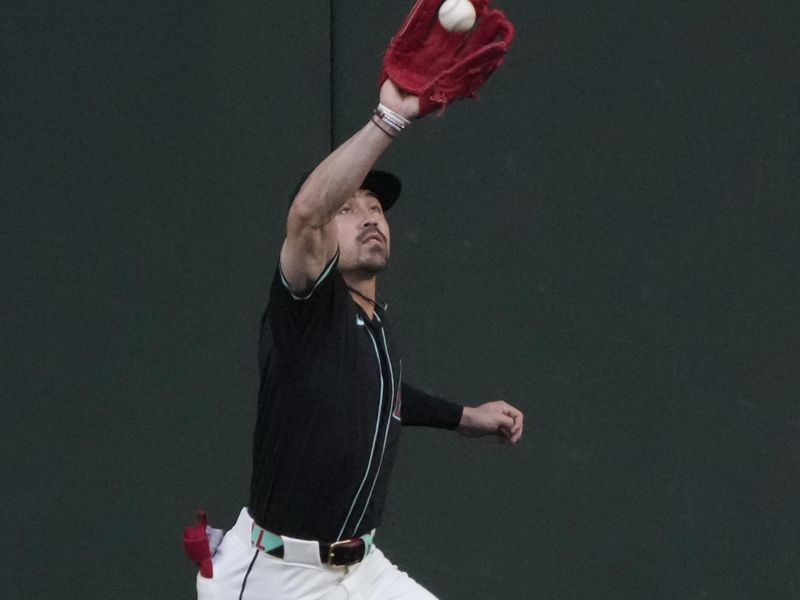 Apr 13, 2024; Phoenix, Arizona, USA; Arizona Diamondbacks centerfielder Corbin Carroll (7) makes the catch against the St. Louis Cardinals in the first inning at Chase Field. Mandatory Credit: Rick Scuteri-USA TODAY Sports