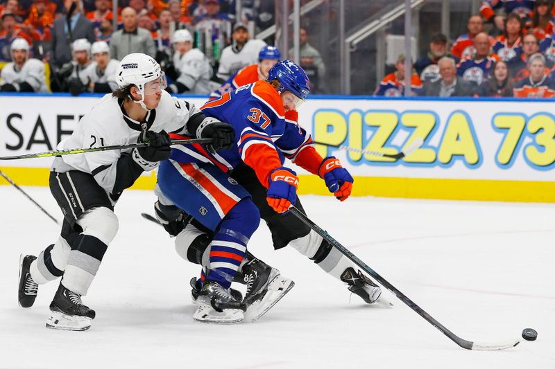 May 1, 2024; Edmonton, Alberta, CAN; Los Angeles Kings defensemen Jordan Spence (21) and defensemen Drew Doughty (8) try to knock the puck away from Edmonton Oilers forward Warren Foegele (37) during the first period in game five of the first round of the 2024 Stanley Cup Playoffs at Rogers Place. Mandatory Credit: Perry Nelson-USA TODAY Sports