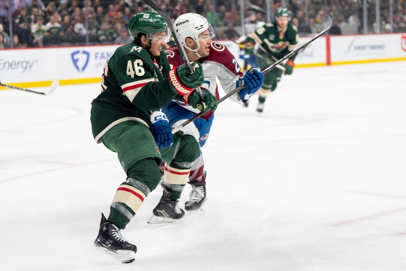 Mar 11, 2025; Saint Paul, Minnesota, USA; Colorado Avalanche center Ross Colton (20) hits Minnesota Wild defenseman Jared Spurgeon (46) in the first period at Xcel Energy Center. Mandatory Credit: Matt Blewett-Imagn Images