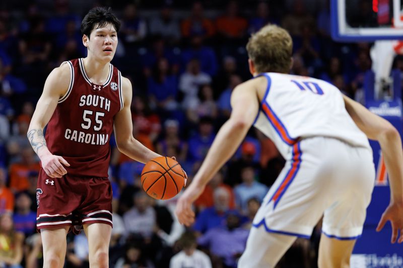 Feb 17, 2026; Gainesville, Florida, USA; South Carolina Gamecocks guard Mike Sharavjamts (55) dribbles the ball while Florida Gators forward Thomas Haugh (10) defends during the first half at Exactech Arena at the Stephen C. O'Connell Center. Mandatory Credit: Matt Pendleton-Imagn Images