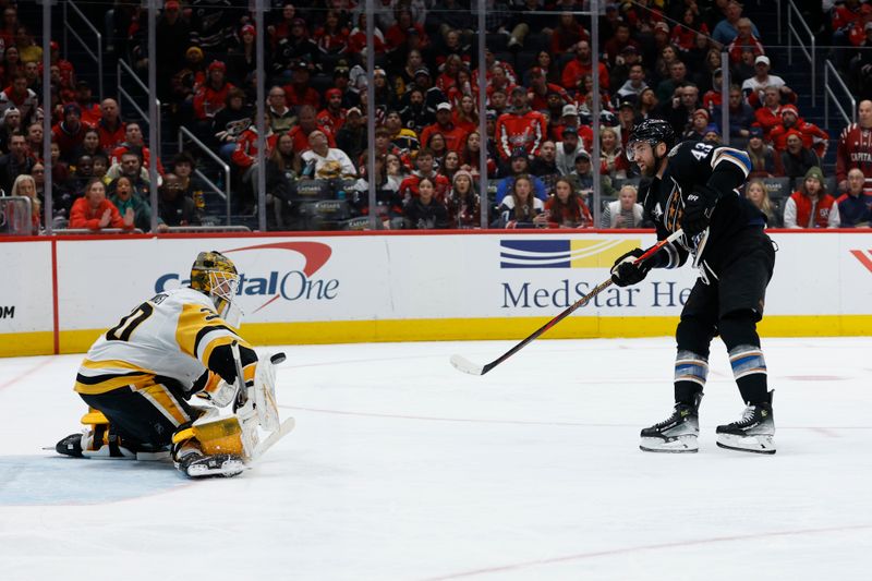 Jan 18, 2025; Washington, District of Columbia, USA; Washington Capitals right wing Tom Wilson (43) shoots the puck on Pittsburgh Penguins goaltender Joel Blomqvist (30) in the third period at Capital One Arena. Mandatory Credit: Geoff Burke-Imagn Images