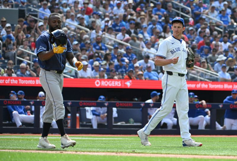 Jul 25, 2024; Toronto, Ontario, CAN; Toronto Blue Jays pitcher Chris Bassitt (40) speaks with Tampa Bay Rays left fielder Randy Arozarena (56) after knocking him down with a pitch in the third inning at Rogers Centre. Mandatory Credit: Dan Hamilton-USA TODAY Sports