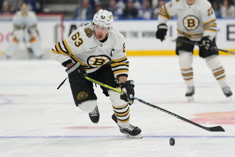 Apr 24, 2024; Toronto, Ontario, CAN; Boston Bruins forward Brad Marchand (63) carries the puck against the Toronto Maple Leafs during the second period of game three of the first round of the 2024 Stanley Cup Playoffs at Scotiabank Arena. Mandatory Credit: John E. Sokolowski-USA TODAY Sports