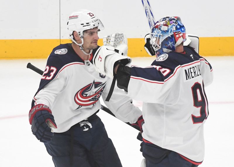 Oct 25, 2025; Pittsburgh, Pennsylvania, USA; Columbus Blue Jackets goalie Elvis Merzlikins (90) celebrates a win over the Pittsburgh Penguins with center Sean Monahan (23) after a shoot-out at PPG Paints Arena. The Blue Jackets won 5-4. Mandatory Credit: Philip G. Pavely-Imagn Images