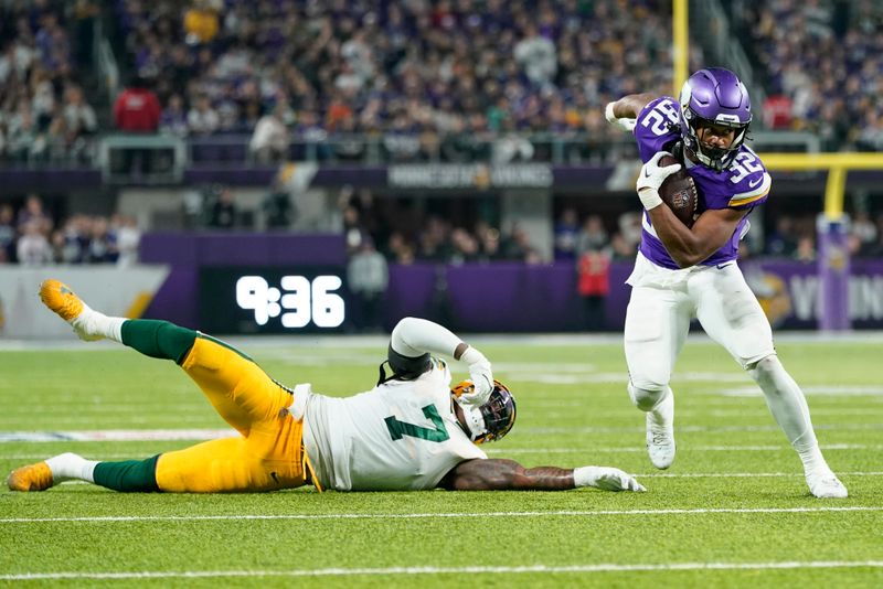 Minnesota Vikings' Ty Chandler gets past Green Bay Packers' Quay Walker during the second half of an NFL football game Sunday, Dec. 31, 2023, in Minneapolis. (AP Photo/Abbie Parr)