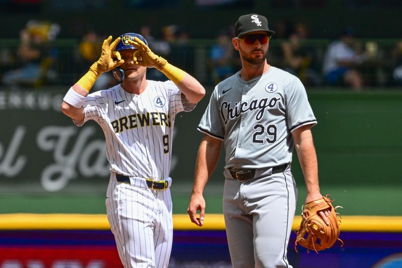 Jun 2, 2024; Milwaukee, Wisconsin, USA; Milwaukee Brewers first baseman Jake Bauers (9) reacts after hitting a double to drive in a run as Chicago White Sox shortstop Paul DeJong (29) looks on in the second inning at American Family Field. Mandatory Credit: Benny Sieu-USA TODAY Sports