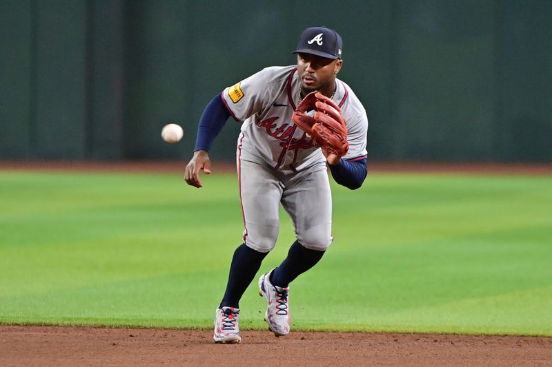 Jul 10, 2024; Phoenix, Arizona, USA;  Atlanta Braves second baseman Ozzie Albies (1) fields a ball in the second inning against the Arizona Diamondbacks at Chase Field. Mandatory Credit: Matt Kartozian-USA TODAY Sports