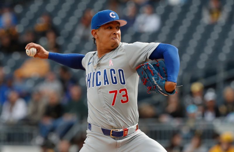 May 12, 2024; Pittsburgh, Pennsylvania, USA;  Chicago Cubs relief pitcher Adbert Alzolay (73) pitches against the Pittsburgh Pirates during the tenth inning at PNC Park. The Cubs won 5-4 in ten innings. Mandatory Credit: Charles LeClaire-USA TODAY Sports