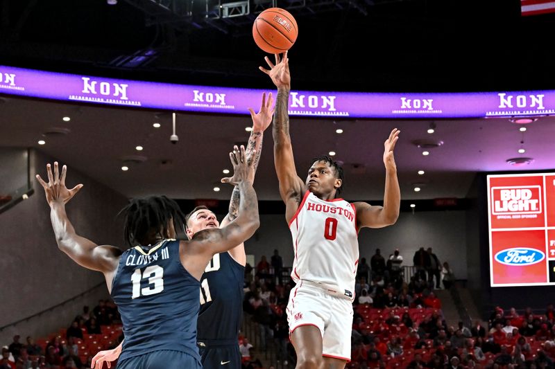 Nov 14, 2022; Houston, Texas, USA; Houston Cougars guard Marcus Sasser (0) shoots over Oral Roberts Golden Eagles guard Carlos Jurgens (11) during the second half at Fertitta Center. Mandatory Credit: Maria Lysaker-USA TODAY Sports