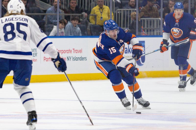 Dec 11, 2023; Elmont, New York, USA; New York Islanders right wing Cal Clutterbuck (15) skates with the puck against the Toronto Maple Leafs during the second period at UBS Arena. Mandatory Credit: Thomas Salus-USA TODAY Sports