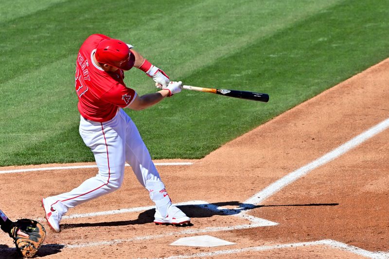 Feb 29, 2024; Tempe, Arizona, USA;  Los Angeles Angels center fielder Mike Trout (27) doubles in the fourth inning against the Cleveland Guardians during a spring training game at Tempe Diablo Stadium. Mandatory Credit: Matt Kartozian-USA TODAY Sports