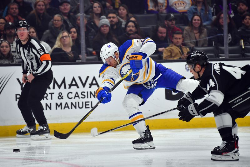 Feb 13, 2023; Los Angeles, California, USA; Buffalo Sabres right wing Kyle Okposo (21) shoots against the defense of Los Angeles Kings defenseman Mikey Anderson (44) during the first period at Crypto.com Arena. Mandatory Credit: Gary A. Vasquez-USA TODAY Sports