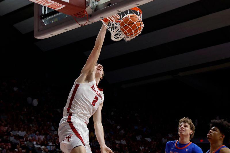 Feb 21, 2024; Tuscaloosa, Alabama, USA; Alabama Crimson Tide forward Grant Nelson (2) slam dunks the ball against the Florida Gators at Coleman Coliseum. Mandatory Credit: Butch Dill-USA TODAY Sports