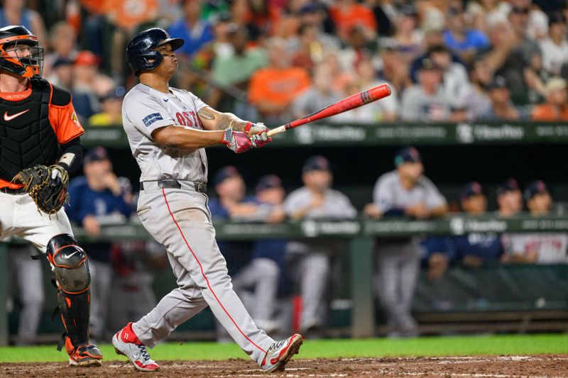 Aug 17, 2024; Baltimore, Maryland, USA; Boston Red Sox third baseman Rafael Devers (11) hits a home run during the eighth inning against the Baltimore Orioles at Oriole Park at Camden Yards. Mandatory Credit: Reggie Hildred-USA TODAY Sports