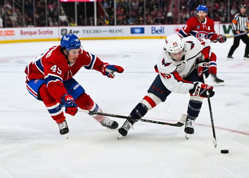 Oct 21, 2023; Montreal, Quebec, CAN; Washington Capitals right wing Matthew Phillips (45) plays the puck against Montreal Canadiens left wing Rafael Harvey-Pinard (49) during the second period at Bell Centre. Mandatory Credit: David Kirouac-USA TODAY Sports