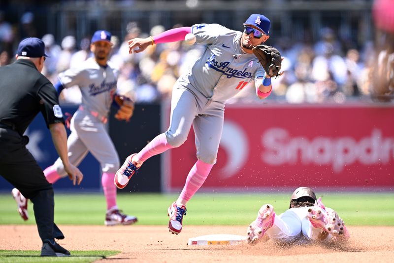 May 12, 2024; San Diego, California, USA; San Diego Padres center fielder Jackson Merrill (3) steals second base ahead off the throw to Los Angeles Dodgers second baseman Miguel Rojas (11) during the fourth inning at Petco Park. Mandatory Credit: Orlando Ramirez-USA TODAY Sports