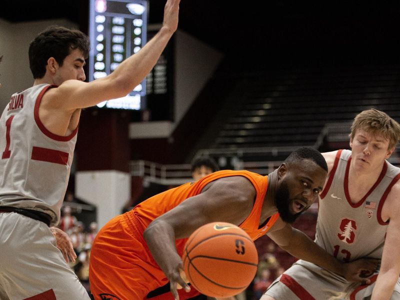 Jan 19, 2023; Stanford, California, USA; Oregon State Beavers forward Rodrigue Andela (center) loses the ball out of bounds as he is defended by Stanford Cardinal guards Isa Silva (1) and Michael Jones (13) during the first half at Maples Pavilion. Mandatory Credit: D. Ross Cameron-USA TODAY Sports