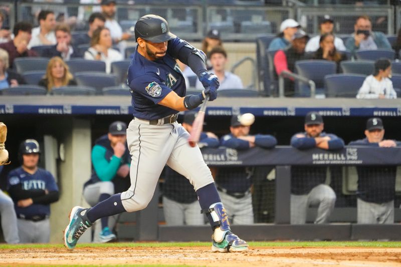 Jun 22, 2023; Bronx, New York, USA; Seattle Mariners second baseman Jose Caballero (76) hits a sacrifice fly ball against the New York Yankees during the third inning at Yankee Stadium. Mandatory Credit: Gregory Fisher-USA TODAY Sports