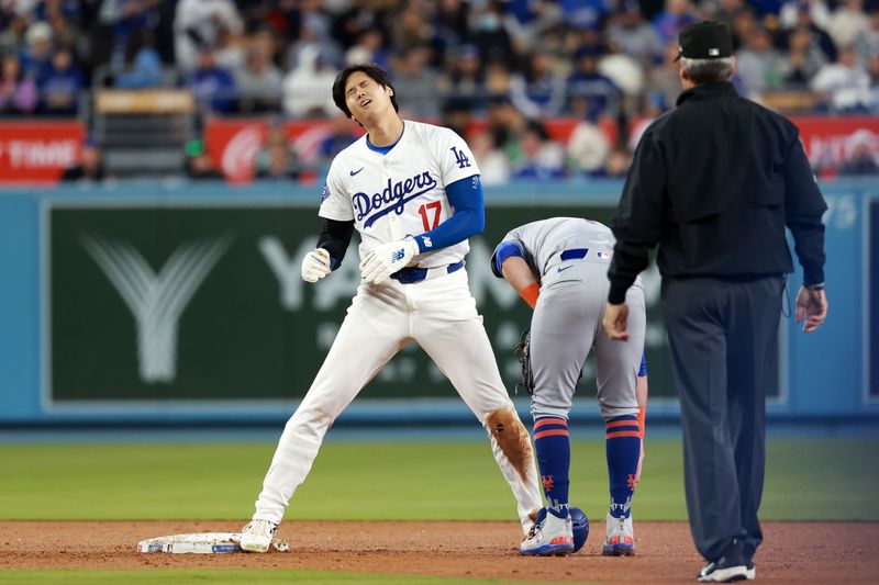 Apr 19, 2024; Los Angeles, California, USA;  Los Angeles Dodgers designated hitter Shohei Ohtani (17) reacts after stealing second base during the fourth inning against the New York Mets at Dodger Stadium. Mandatory Credit: Kiyoshi Mio-USA TODAY Sports